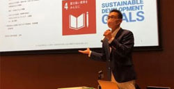 A speaker giving a presentation at a lecture
